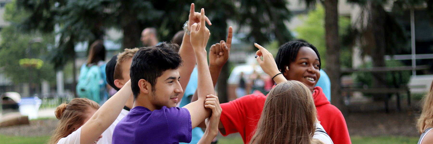 Students standing and smiling outside