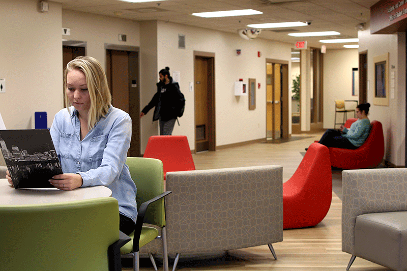 A photo of students sitting in furniture and studying.